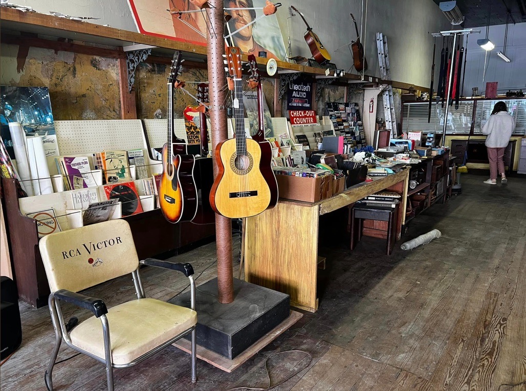 Inside the Gist Music store, with guitars, vinyl records, and vintage furnishings
